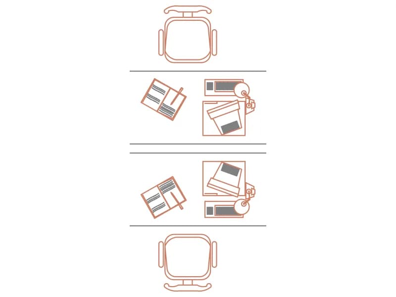 Plan-view CAD block of two facing desks with computers, phones and task chairs